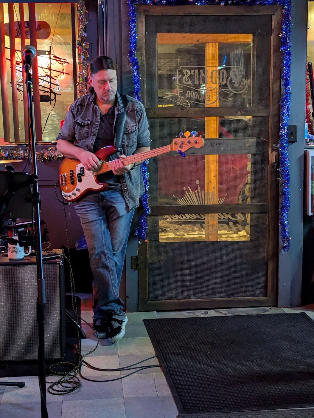 Denny Menter playing bass guitar at Brodhi's Saloon